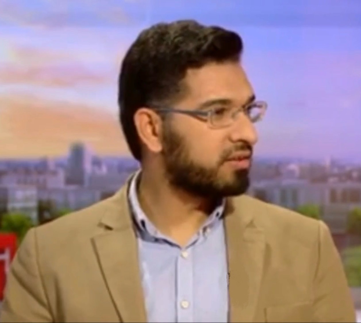Dr Tarek Hosny wearing glasses and a tan jacket